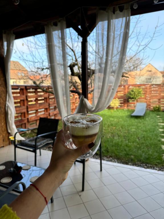a person is holding a glass of beer at Gusterita Hideaway in Sibiu