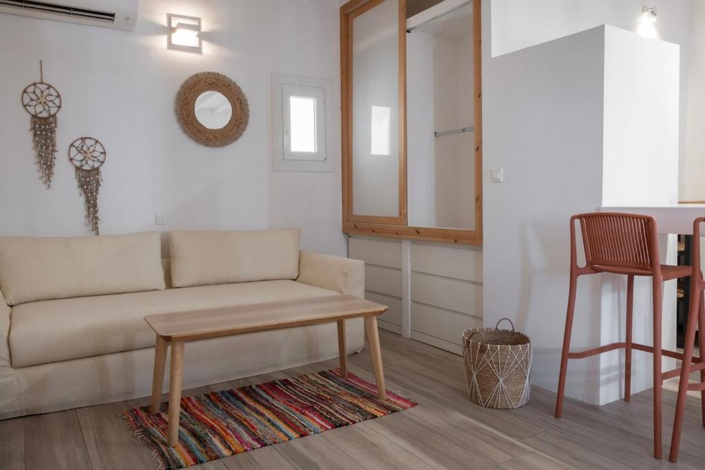 una sala de estar con un sofá y una mesa en Casa Poco, 150 meters from Ornos Beach, en Ornos
