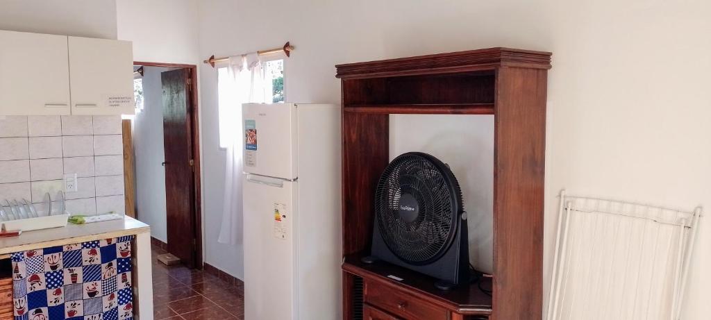 a kitchen with a refrigerator and a grandfather clock at Luana2 in Villa Gesell