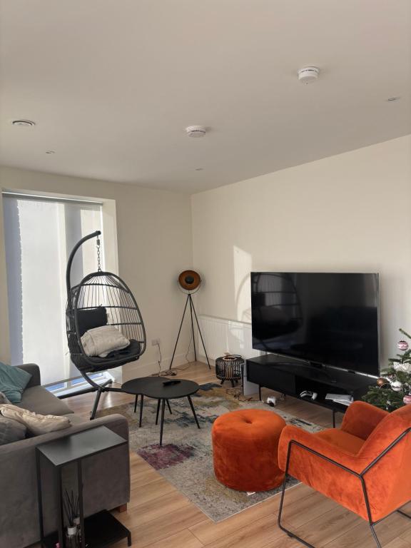 a living room with a couch and a tv at Modern-Spacious Dublin Apartment in Dublin