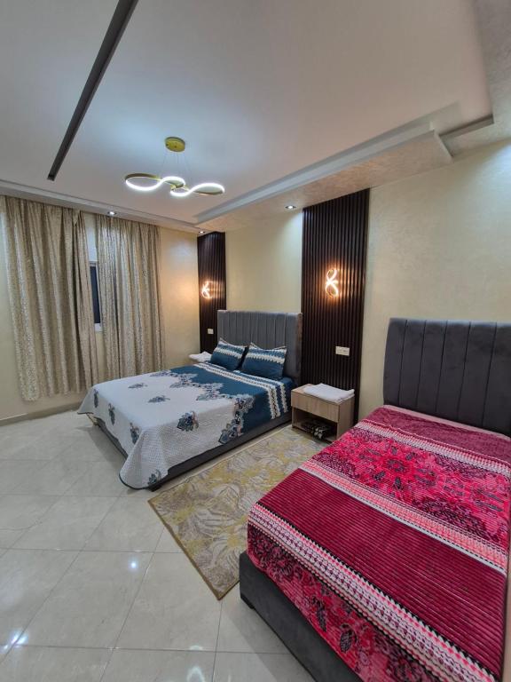a bedroom with two beds and avisor at Appartement meublé à louer à l'avant 4 T in Yebha
