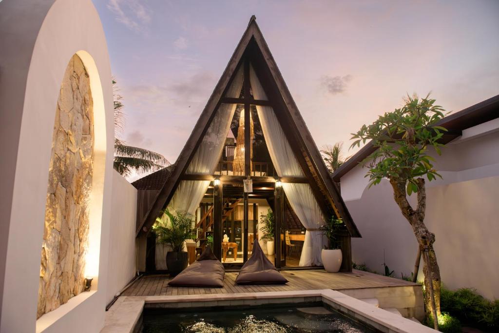 a house with a pond in front of it at Private villa 1 bedrooms Kaba-kaba tabanan in Kapal