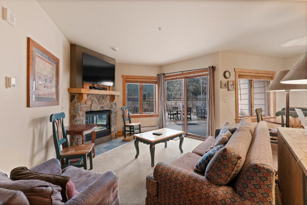 a living room with a couch and a fireplace at Red Hawk Lodge #2204 in Keystone