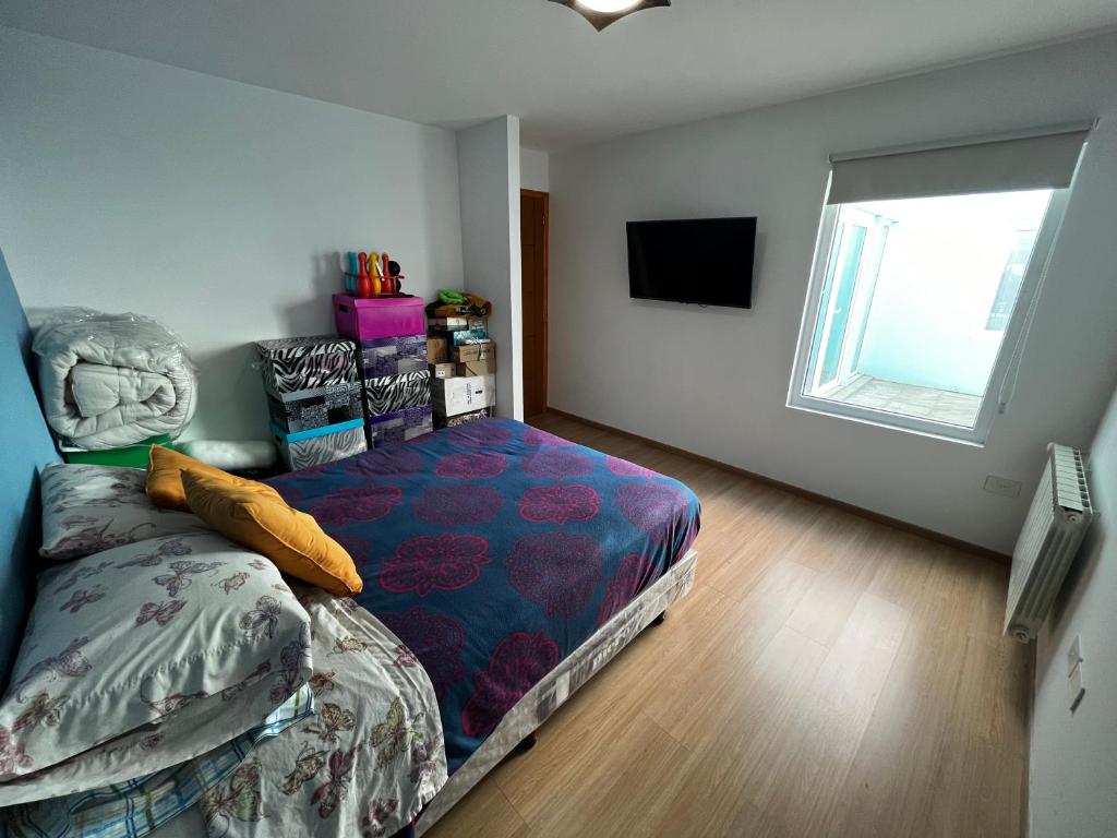 Giường trong phòng chung tại Veni a relajarte