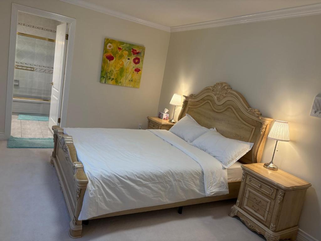 a bedroom with a large bed and a window at Cozy home near YVR with free parking in Richmond