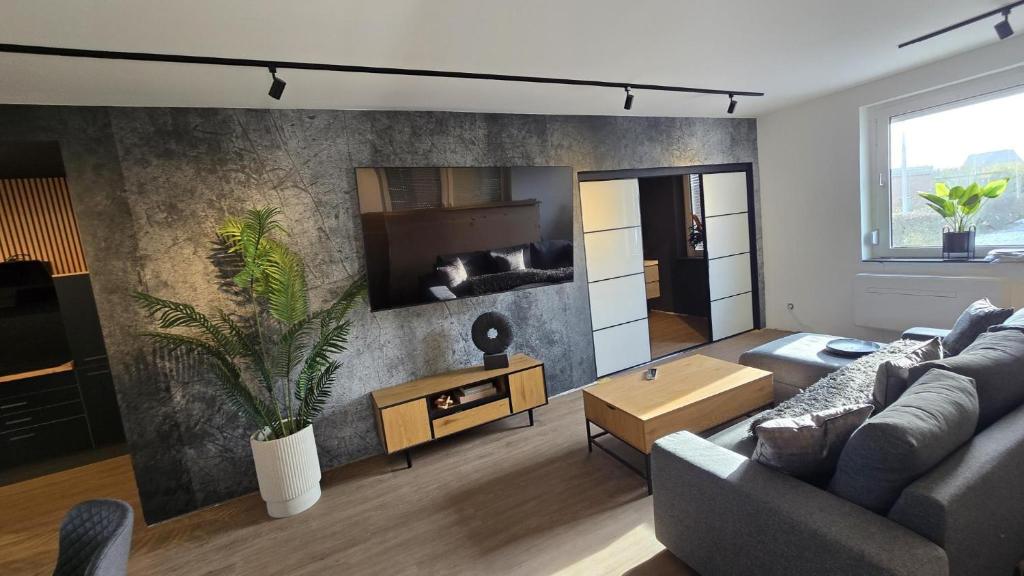 a living room with a couch and a table at Ferienhaus-Kleine-Austernperle in Dornumersiel