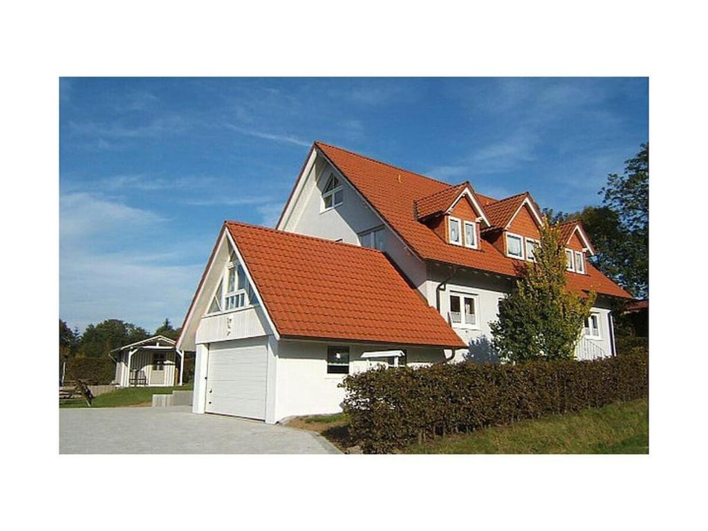 a large white house with an orange roof at Holiday apartment with 1 bedroom in Herbstein