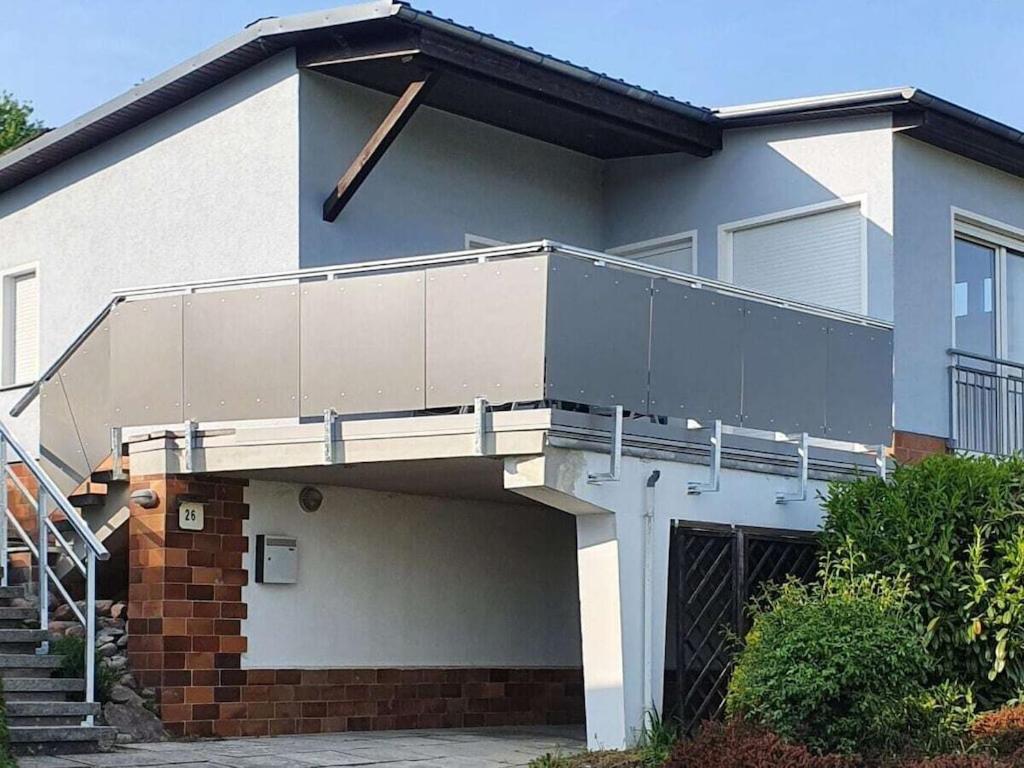 a house with a balcony on the side of it at Holiday home on Lake Kummerow in Salem
