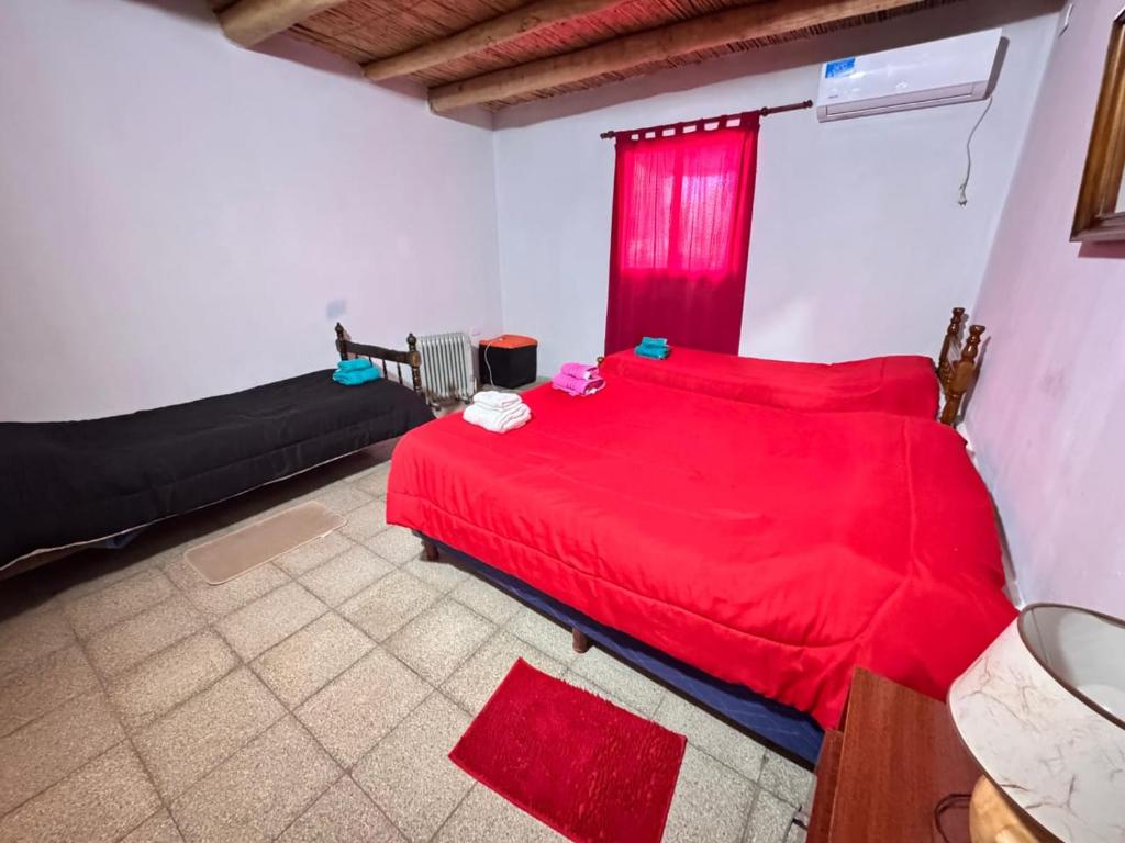 En eller flere senge i et værelse på Departamento Guadalupe