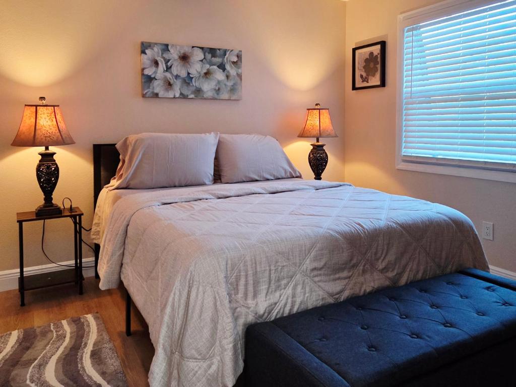 a bedroom with a large bed with two lamps at Toria Suites Condo 924 in Lakeland