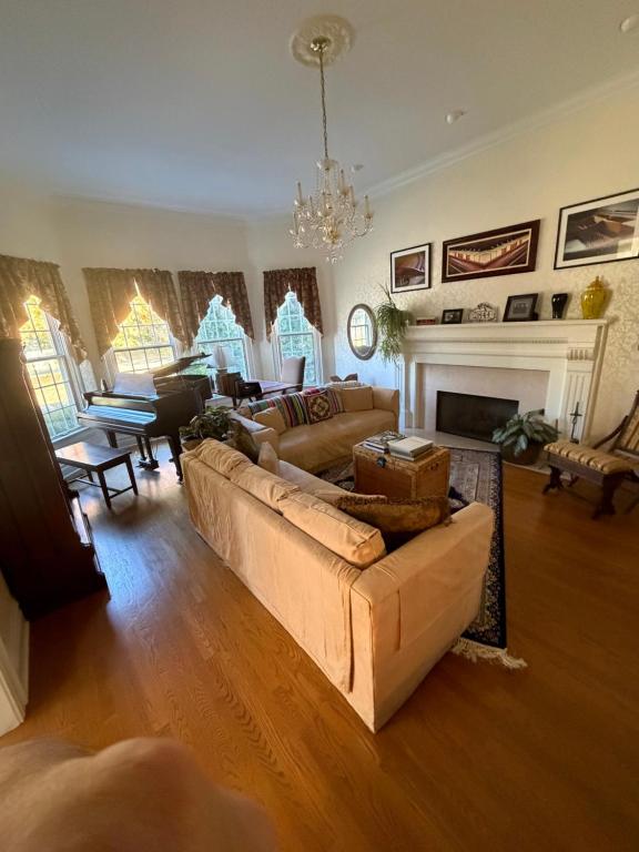 a living room with a couch and a fireplace at Exquisite Victorian in Springfield