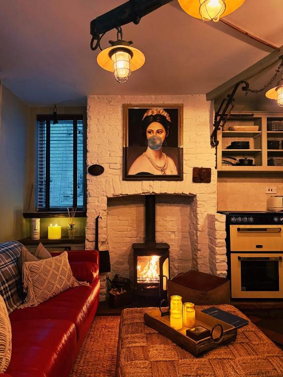 a living room with a couch and a fireplace at Rose Cottage in Whitby
