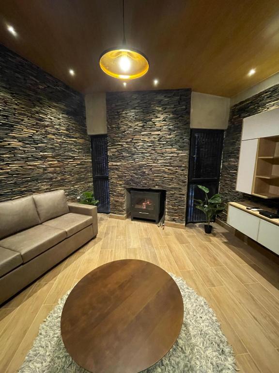 a living room with a couch and a fireplace at Rent House in El Rodeo