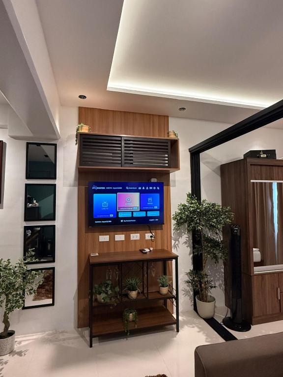 a living room with a flat screen tv on a wall at Condo unit with balcony in Lapu Lapu Cebu in Mactan Island