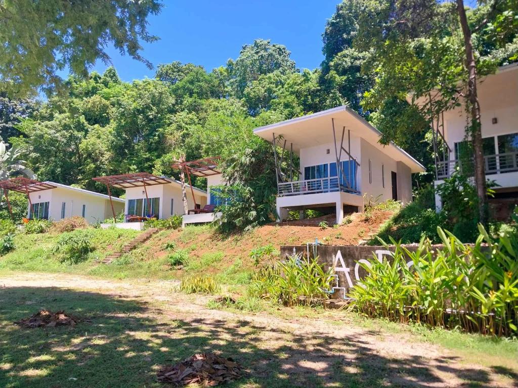 a row of houses on a hill with trees at AoPong Resort in Ko Mak