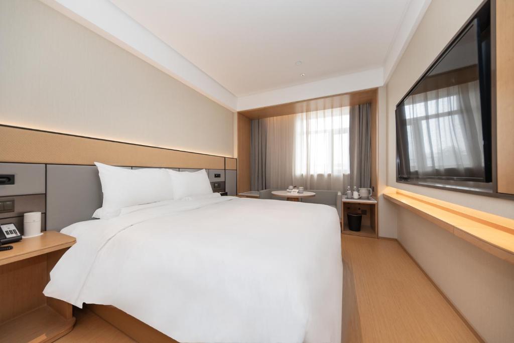 Кровать или кровати в номере JI Hotel Shanghai Xinzhuang Qixin Road Qixin Road