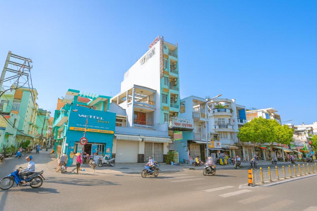a group of people riding motorcycles down a city street at Như Quỳnh Hotel HCM in Ho Chi Minh City