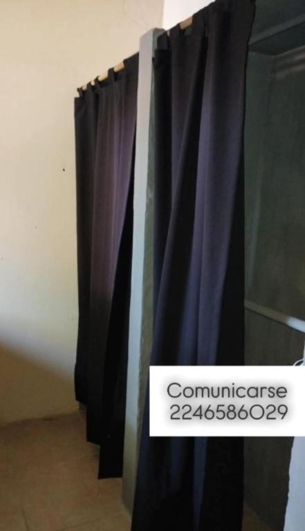 a black curtain with a sign that reads commnesia at Costero in Santa Teresita
