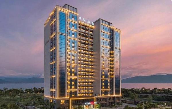 a rendering of a tall building with lights on at Intercity Hotel Dali Erhai Park in Dali