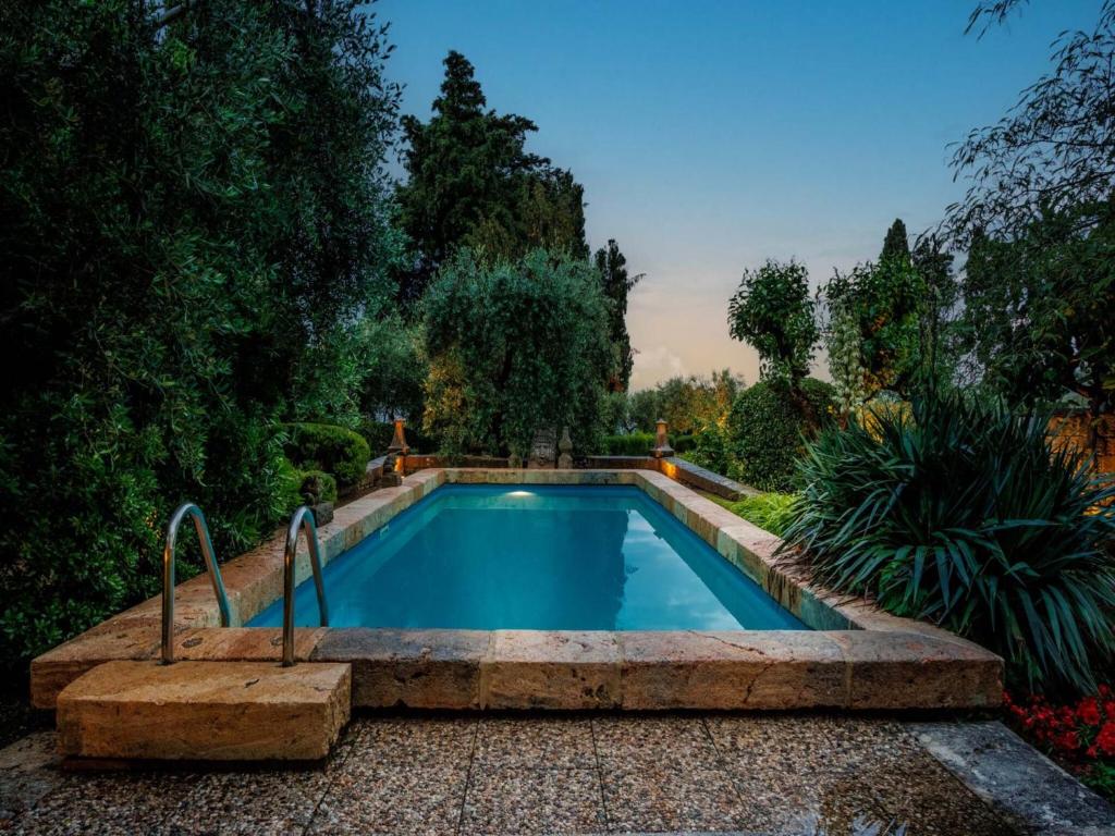 a swimming pool in a garden with trees at Villa in Cetona close to Rome in Cetona