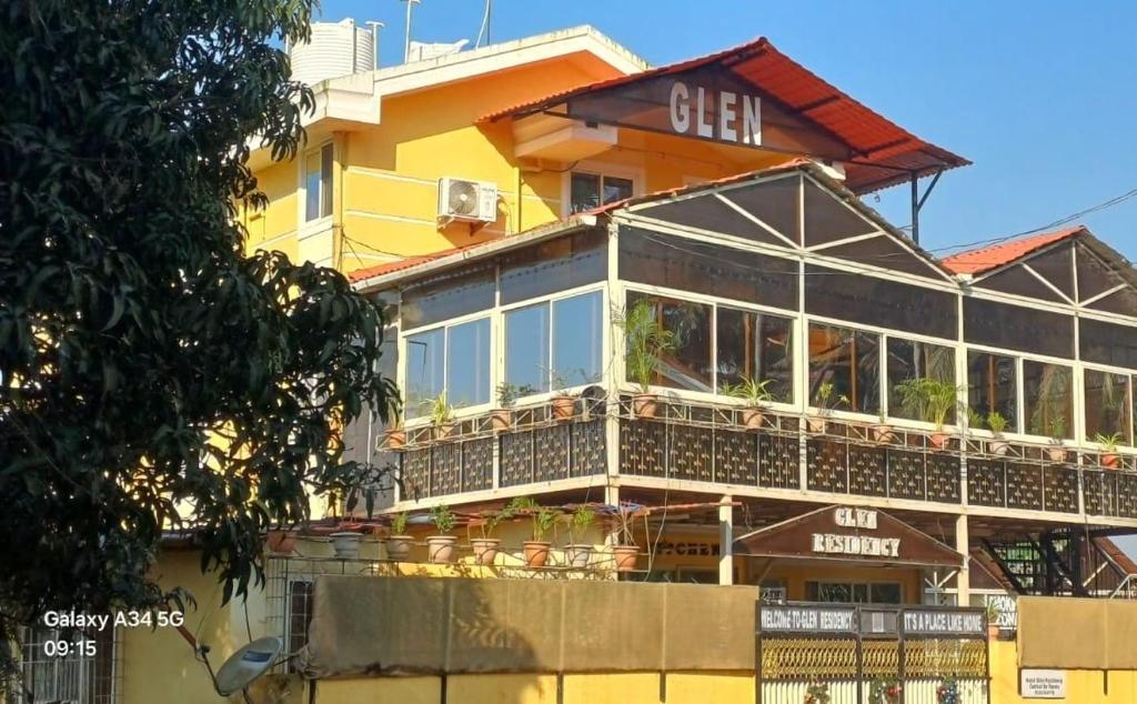a large yellow building with a balcony at GLEN RESIDENCY in Chinchinim