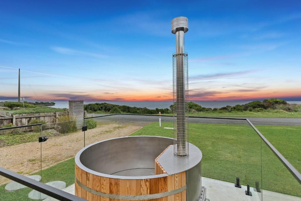 a hot tub with a pole in the middle of a field at The Breakers in Sunderland Bay