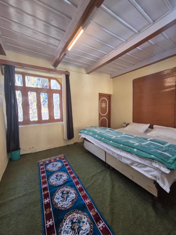 En eller flere senge i et værelse på Ganga Homstay Rakchham