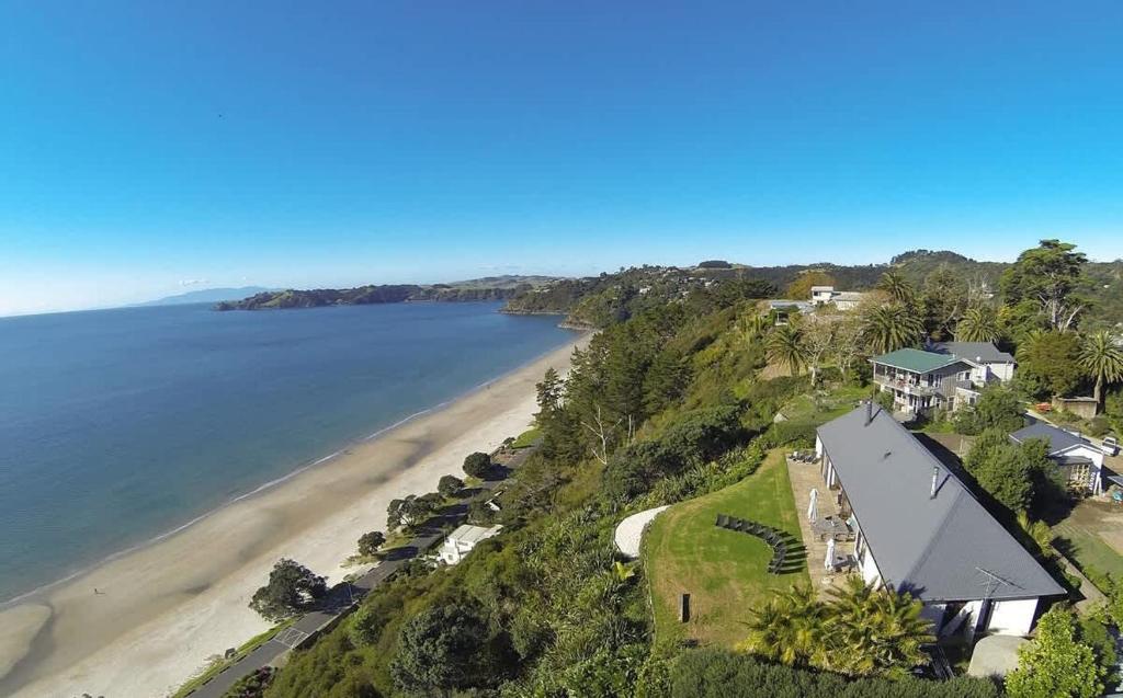 an aerial view of a house and a beach at The Pah - Stay Waiheke in Onetangi