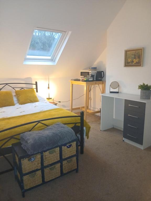 ein Schlafzimmer mit Bett, Schreibtisch und Fenster in der Unterkunft Uplands Room in Sketty