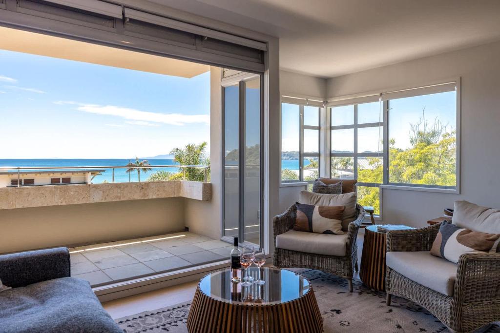 a living room with a view of the ocean at The Sands - Apartment 5 - Stay Waiheke in Onetangi