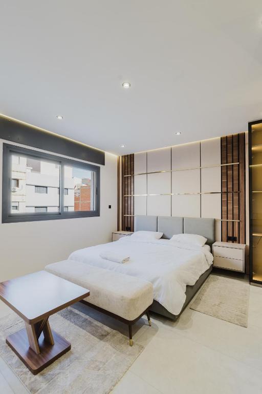 a bedroom with two beds and a table at Studio sky lux 94 in Tangier