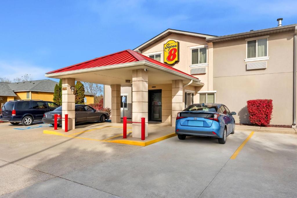 a gas station with a car parked in front at Super 8 by Wyndham Bloomington University Area in Bloomington