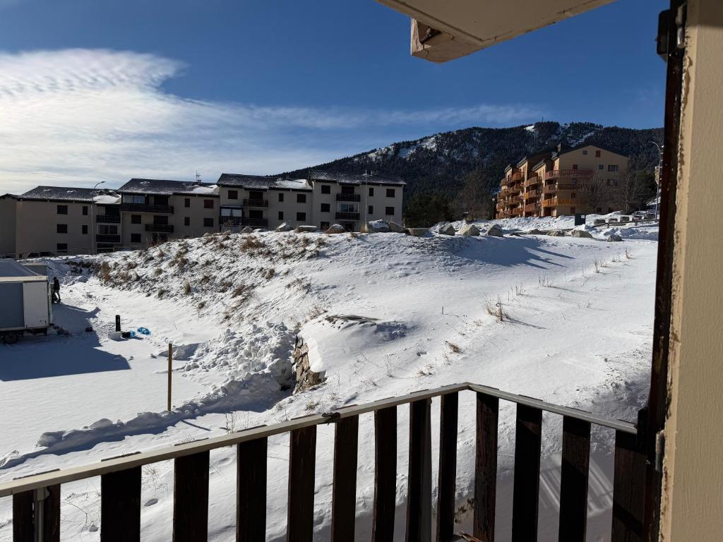 a view from a balcony of a snow covered city at STUDIO LES JONQUILLES in Les Angles