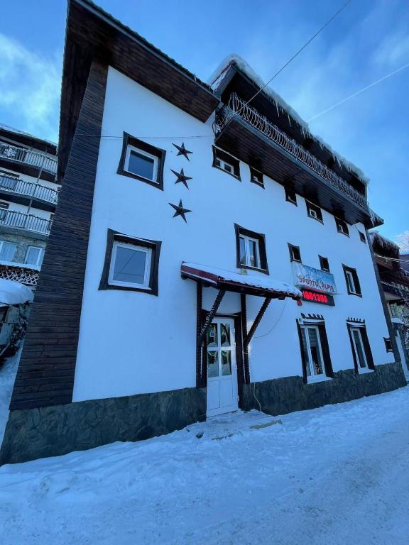 a building with stars on it in the snow at Sportul Alpin in Lupeni