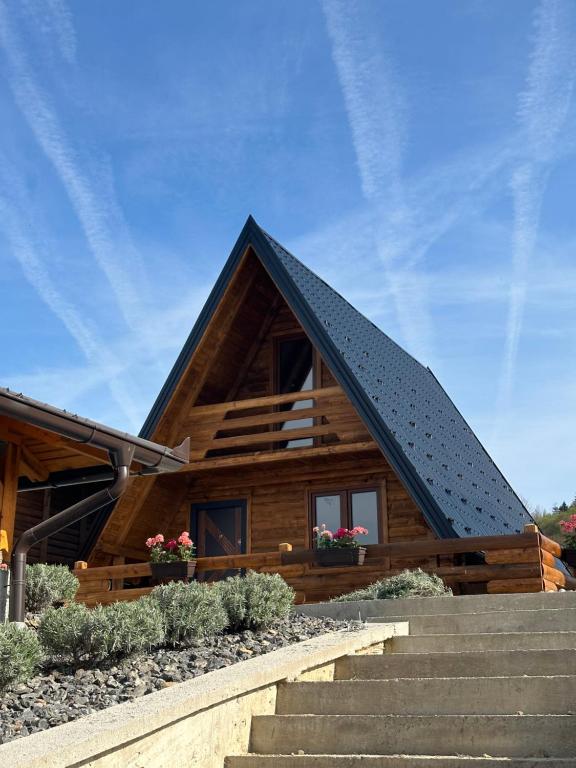 a log house with stairs in front of it at Una Relax in Vajagići