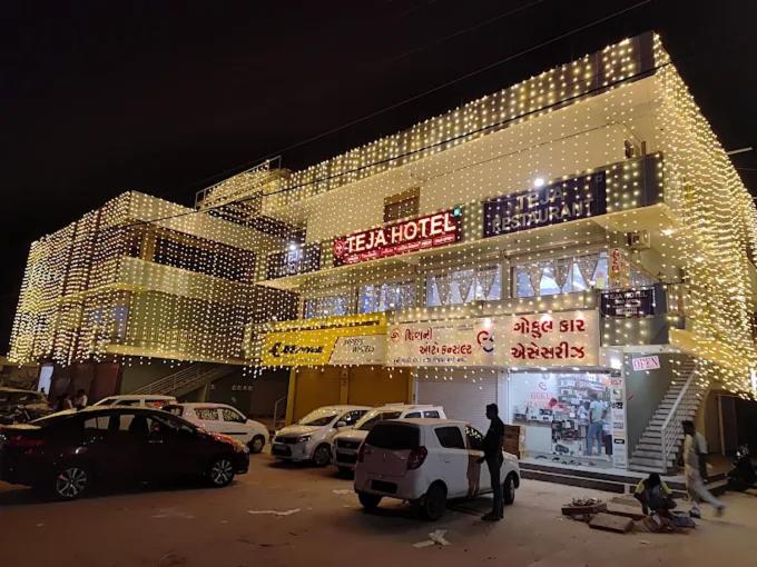 a large building with cars parked in front of it at Teja Hotel in Lūnāvāda