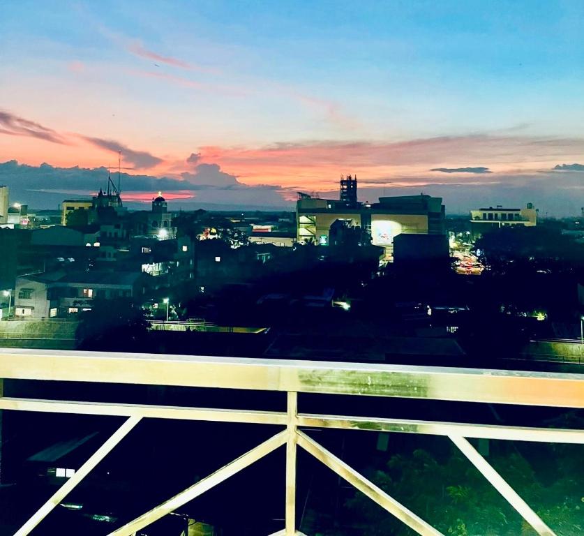 a view of a city skyline at sunset at Naga City River View 2BR UB Apartment in Naga