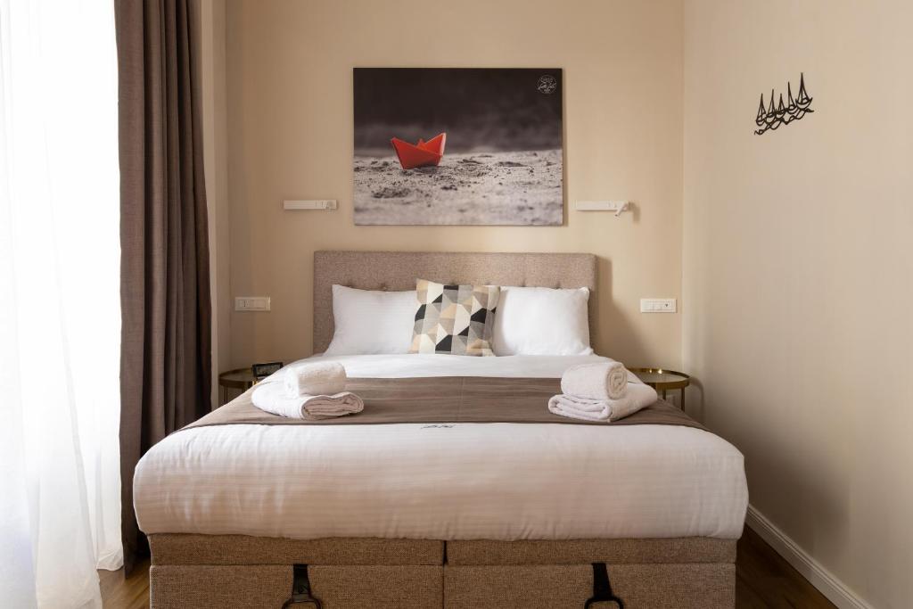a bedroom with a bed with a red boat in it at Sette Vele Rooms in Trieste