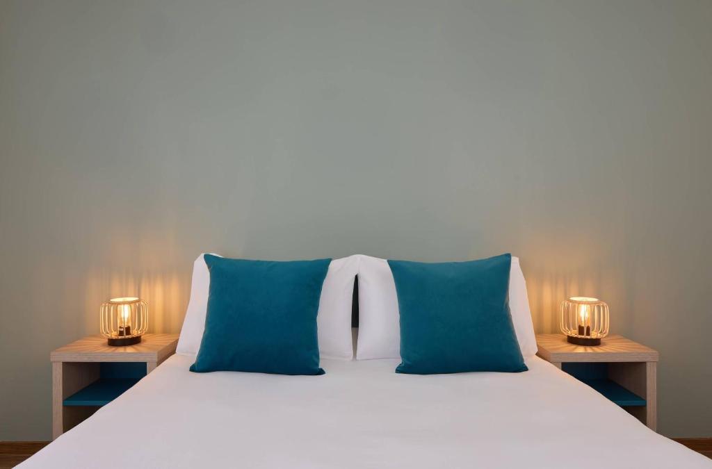 Ένα ή περισσότερα κρεβάτια σε δωμάτιο στο Zenitude Quality Aparthotel Valenciennes