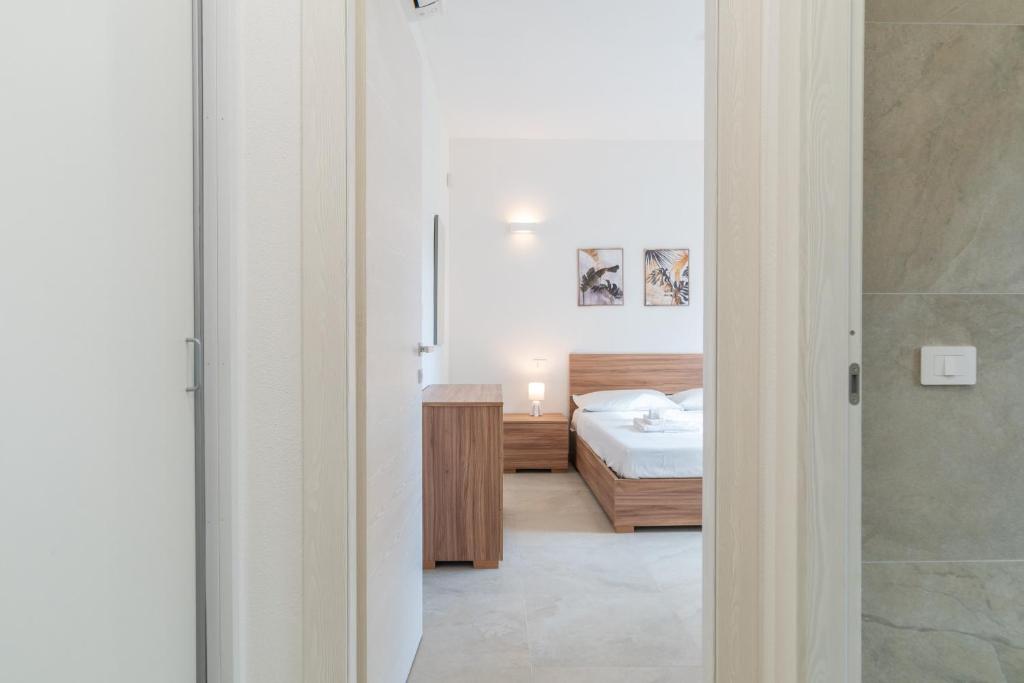 a bedroom with a bed and a bathroom at Brorent A & L apartment B in Golfo Aranci