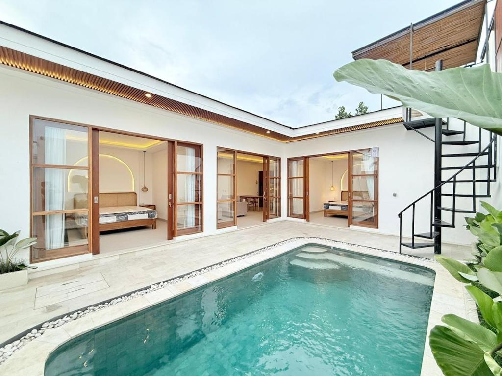 a swimming pool in the backyard of a house at Villa in the Heart of Pererenan Prime Location in Munggu