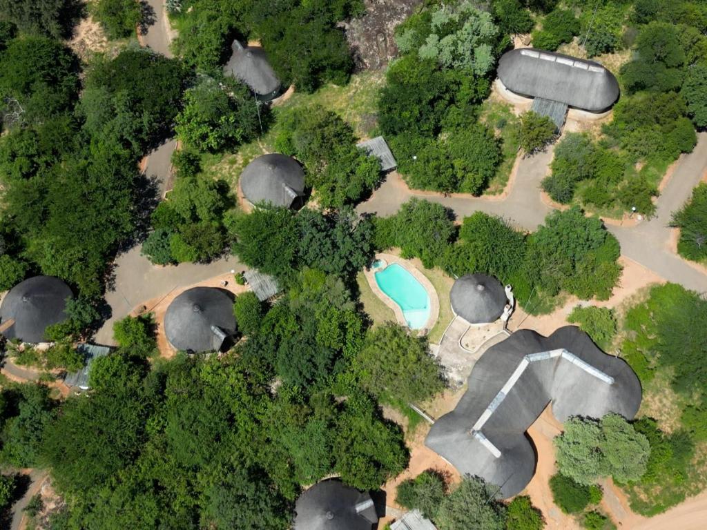an overhead view of a park with trees and water at Awelani Eco Tourism Lodge in Masisi