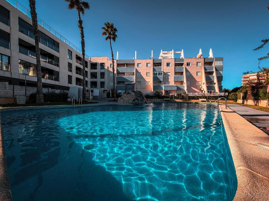 a large swimming pool in front of a building at LaMata Apartament in La Mata