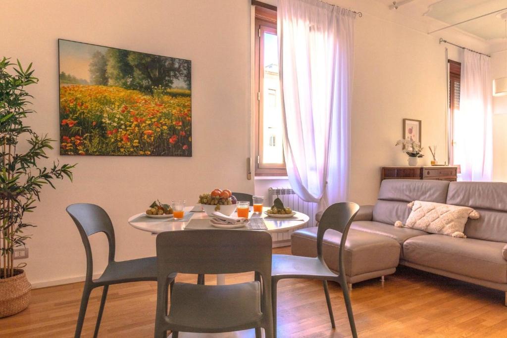 a living room with a table and a couch at Maison 161 in Rieti