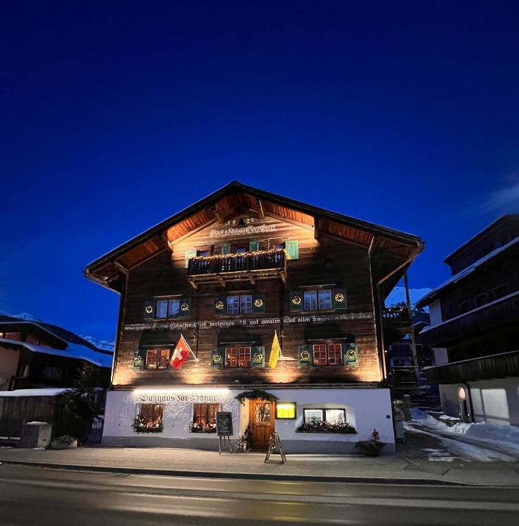a large wooden building with lights on it at Sonne in Klosters