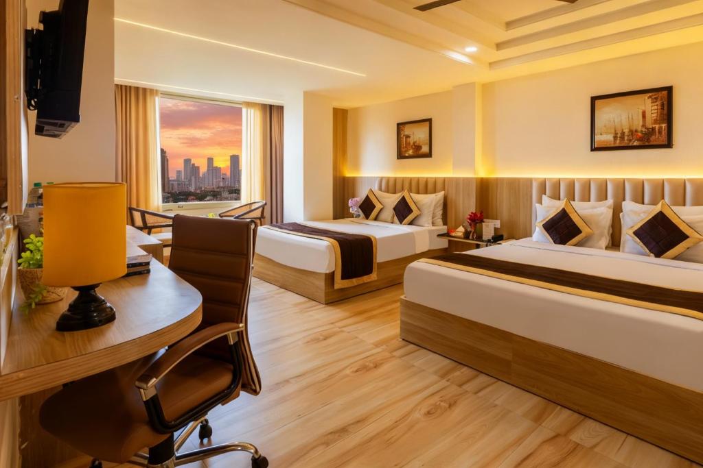 a hotel room with two beds and a desk at Dahabi Venue Premium- Free Airport Pick up or Drop in New Delhi
