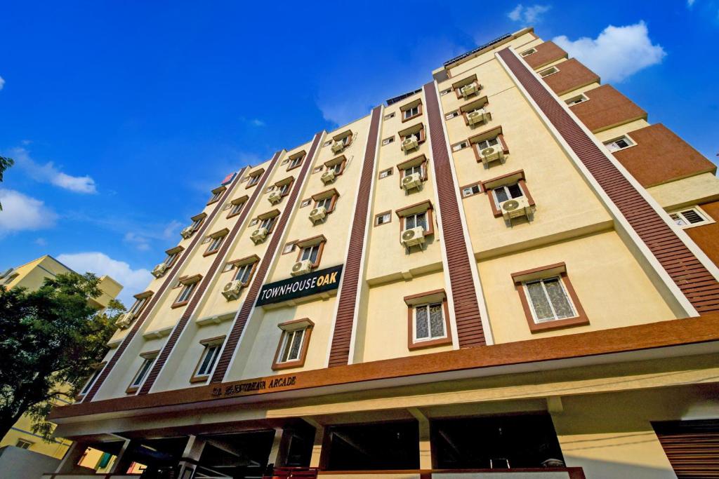 a tall building with balconies on the side of it at Super Townhouse Oak Bachupally Medical College Formerly SV Hotels in Lingampalli