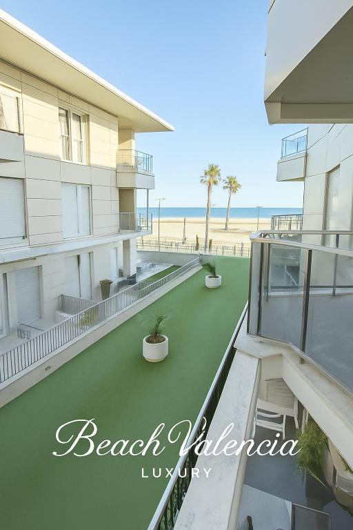 a view of the beach from the balcony of a building at BEACH VALENCIA LUXURY A40-13 Apartment with terrace and sea views in Valencia