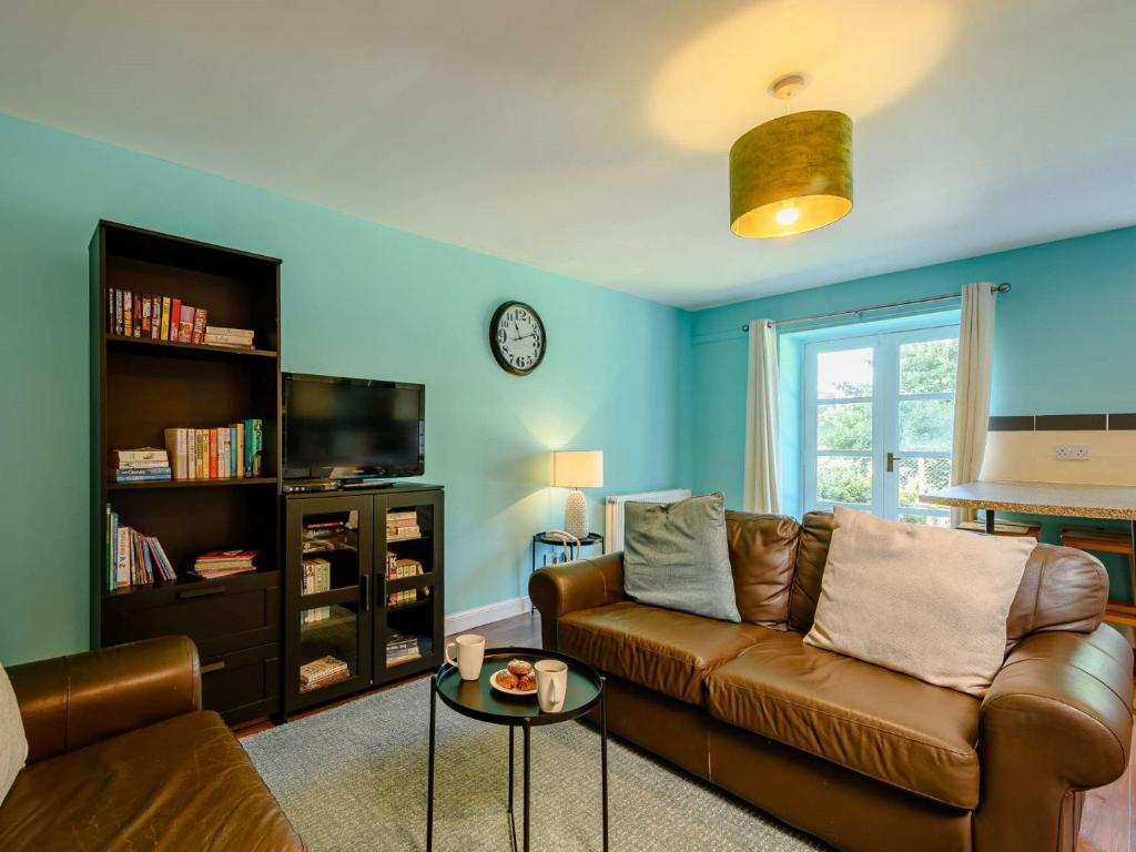 a living room with a couch and a tv at 2 Bed in Sanquhar 89402 in Sanquhar