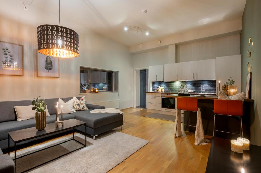 a living room with a couch and a table at Midtbyen Apartment in Trondheim